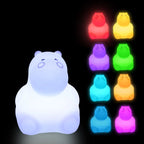 Colorful bear-shaped night lights on a black background
