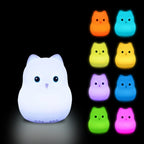 White cat-shaped night light with colorful options on a black background