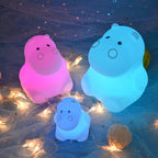 Three colorful animal-shaped lights on a decorative background with string lights.
